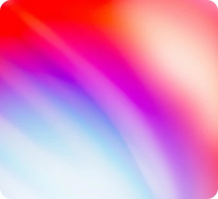 Soft blurred gradient transitioning between red, pink, purple, and blue tones.